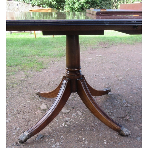 26 - A The Thomas Glenister Company High Wycombe regency style mahogany pedestal dining table, with two l... 