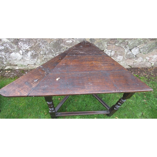 28 - An Antique oak corner table, of triangular form, 43ins x 25ins, height 30ins