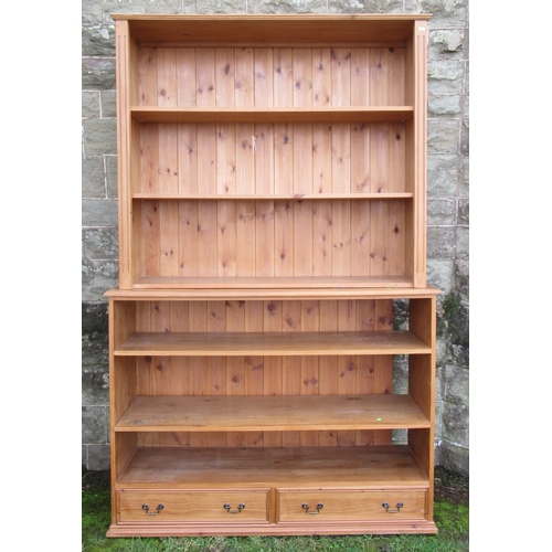 35 - A pine double bookcase, fitted with two drawers to the base, width 54ins, depth 16ins, height 84ins