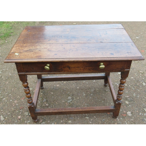 39 - An Antique oak table, fitted with a frieze drawer, on turned legs united by stretchers, 23ins x 36in... 