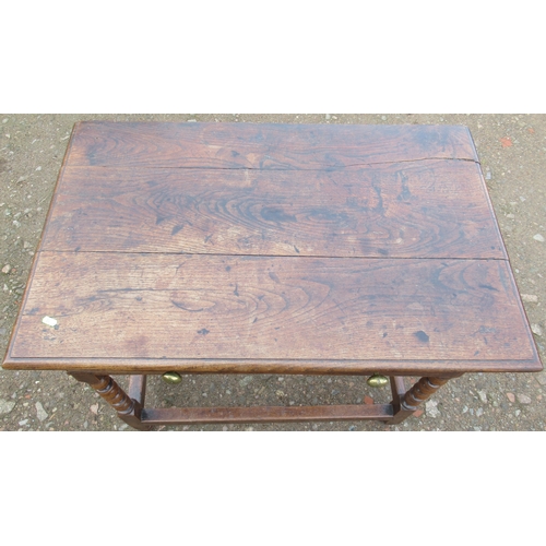 39 - An Antique oak table, fitted with a frieze drawer, on turned legs united by stretchers, 23ins x 36in... 