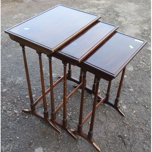 40 - A nest of three mahogany tables, 19ins x 13ins, height 26.5ins and down