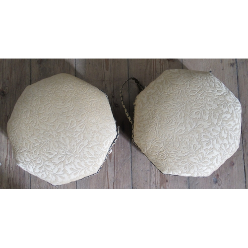 58 - A pair of Victorian walnut and upholstered octagonal foot stools, raised on porcelain feet