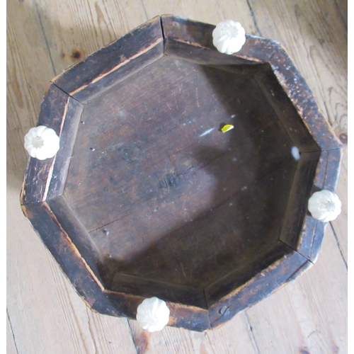 58 - A pair of Victorian walnut and upholstered octagonal foot stools, raised on porcelain feet