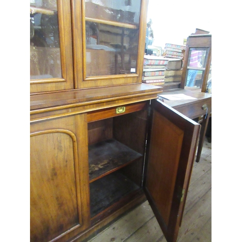 52 - A 19th century mahogany bookcase cabinet, the upper section fitted with a pair of glazed doors with ... 