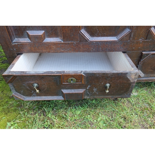 11 - An 18th century oak mule chest, with moulded front panels, over two drawers, with a plain raising li... 