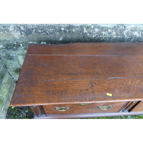 20 - An early 19th century oak three drawer dresser base, raised on turned front legs, width 78ins