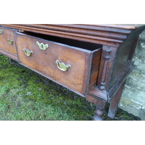 20 - An early 19th century oak three drawer dresser base, raised on turned front legs, width 78ins