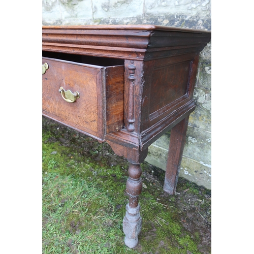 20 - An early 19th century oak three drawer dresser base, raised on turned front legs, width 78ins