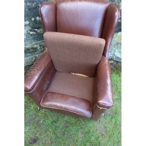 23 - A leatherette upholstered arm chair