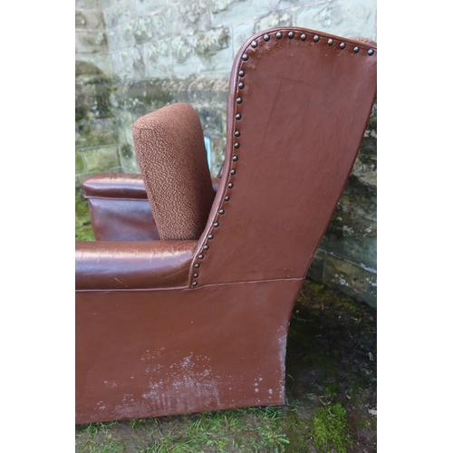 23 - A leatherette upholstered arm chair