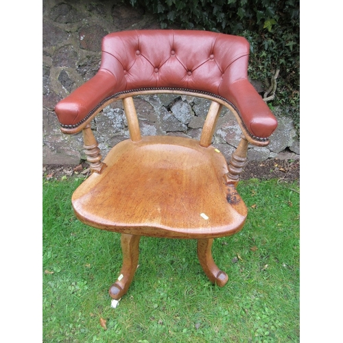 32 - A 19th century saddle seat swivel office chair, with open gallery supporting a leather or leatherett... 