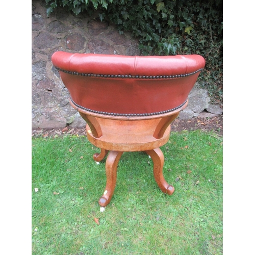 32 - A 19th century saddle seat swivel office chair, with open gallery supporting a leather or leatherett... 