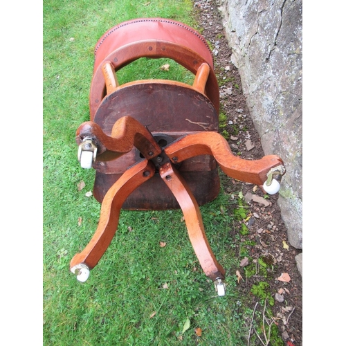 32 - A 19th century saddle seat swivel office chair, with open gallery supporting a leather or leatherett... 