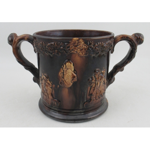 421 - A Victorian treacle glaze loving mug, decorated with a bust of Nelson and tavern scenes, frogs to th... 