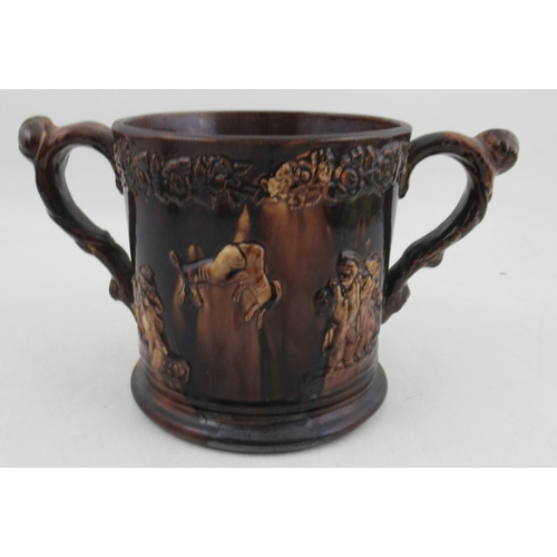 421 - A Victorian treacle glaze loving mug, decorated with a bust of Nelson and tavern scenes, frogs to th... 