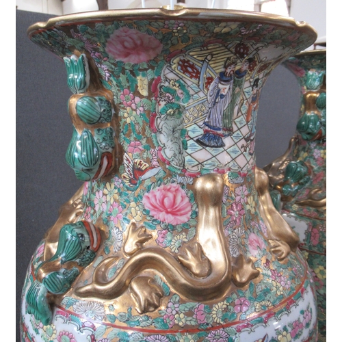 431 - A pair of 20th century Chinese famille rose vases, converted to lamps, decorated with warriors and f... 