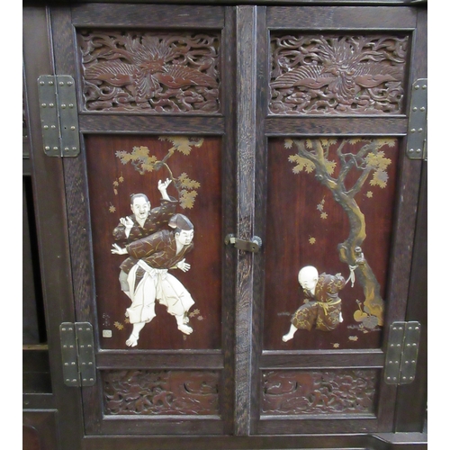 5 - A Japanese shibayama cabinet, fitted with shelves, cupboards and drawers, decorated with flowers, in... 