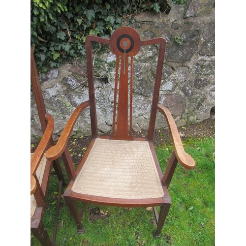 6 - A set of six oak dining chairs, with pewter and ebonized inlay, in the style of George Montague Ellw... 