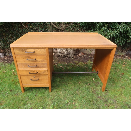 60 - A vintage oak knee hole desk, fitted to one side five graduated drawers, 48ins x 24ins x 29.5ins