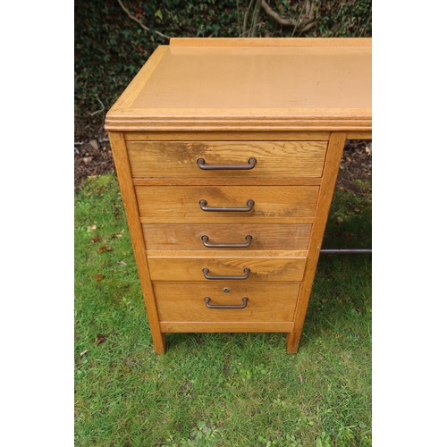 60 - A vintage oak knee hole desk, fitted to one side five graduated drawers, 48ins x 24ins x 29.5ins