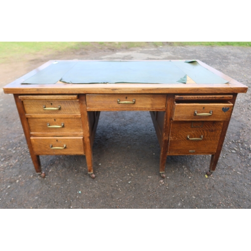 63 - An early 20th century oak desk, fitted with a central drawer, flanked by drawers and sides, 60ins x ... 