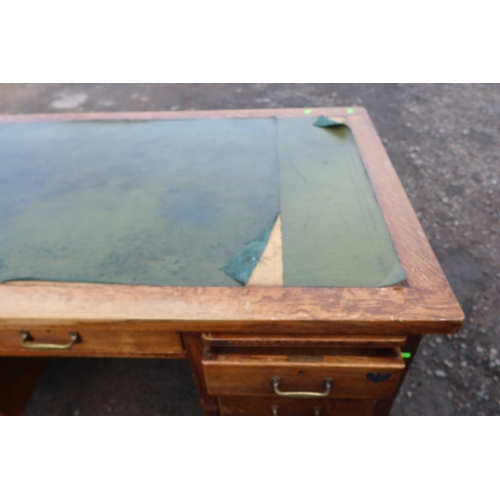 63 - An early 20th century oak desk, fitted with a central drawer, flanked by drawers and sides, 60ins x ... 