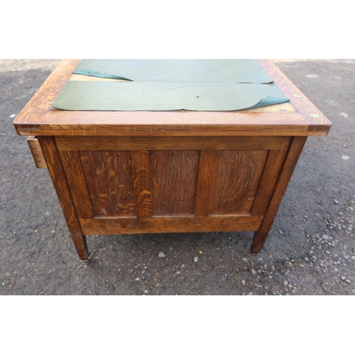 63 - An early 20th century oak desk, fitted with a central drawer, flanked by drawers and sides, 60ins x ... 