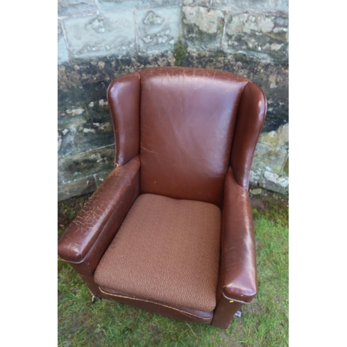 10 - A leatherette upholstered arm chair