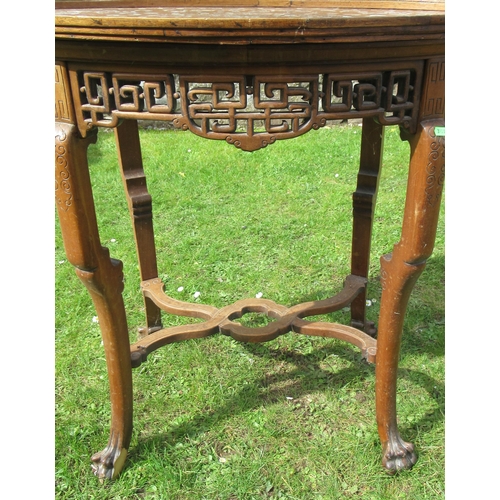 11 - An Eastern oval wooden and inlaid occasional table, inlaid with mother of pearl, having a pierced fr... 