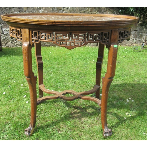 11 - An Eastern oval wooden and inlaid occasional table, inlaid with mother of pearl, having a pierced fr... 