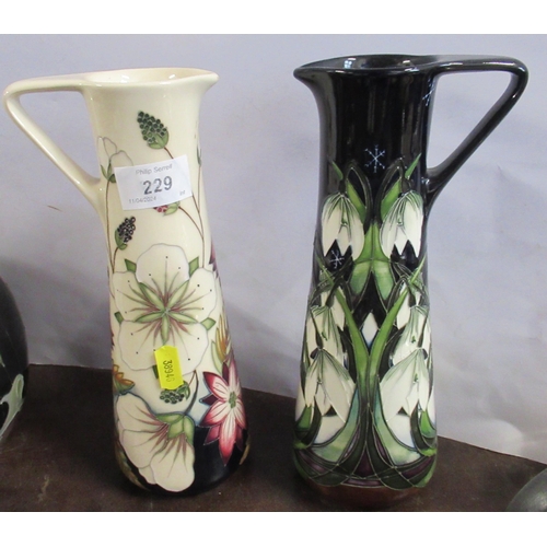 229 - Two Moorcroft jugs, decorated in the 'Bramble revisited' and 'Winter Cascade' patterns, height 9.5in... 