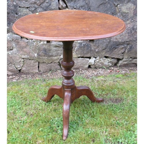 51 - A 19th century oak tripod table, raised on a turned column, with three outswept supports, diameter 2... 