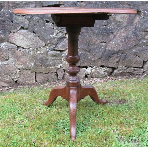 51 - A 19th century oak tripod table, raised on a turned column, with three outswept supports, diameter 2... 