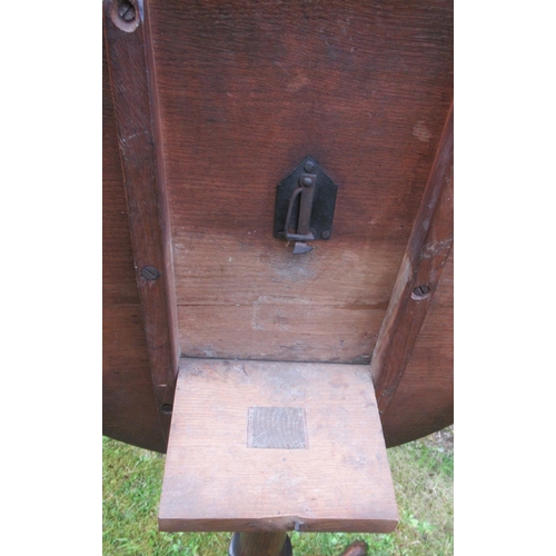 52 - A 19th century oak tilt top tripod table, raised on a turned column, with three outswept supports, d... 