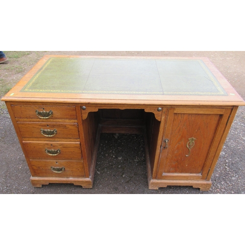 78 - An oak desk, with tooled leather writing surface, the ne pedestal fitted with four drawers, the othe... 