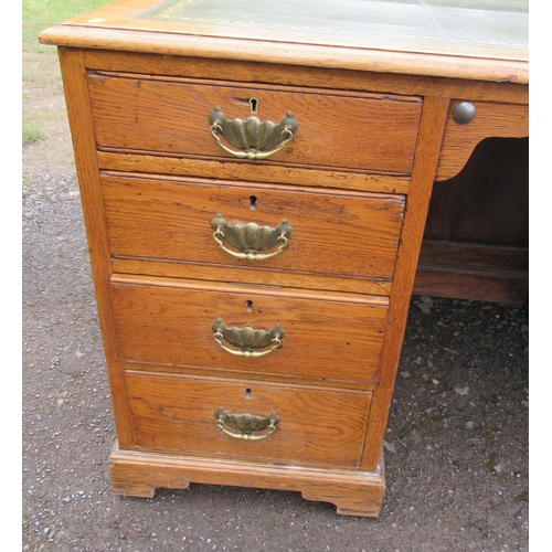 78 - An oak desk, with tooled leather writing surface, the ne pedestal fitted with four drawers, the othe... 