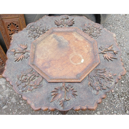 89 - A carved top table, diameter 30ins, together with carved panels and a circular carved panel and two ... 