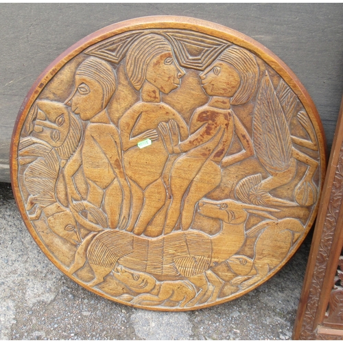 89 - A carved top table, diameter 30ins, together with carved panels and a circular carved panel and two ... 