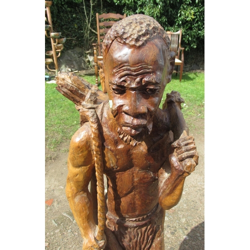 97 - An ethnic carved wooden figure, height 37ins