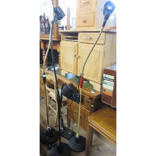 30 - Three floor standing lamps, together with a magnifier