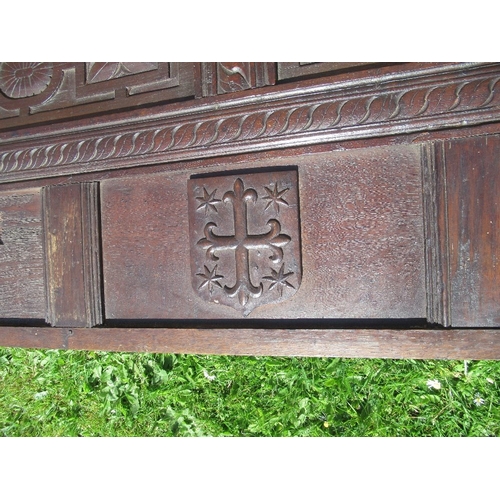 15 - An Antique oak carved panel, with fielded panels  decorated with figure and crest, dated 1633, width... 