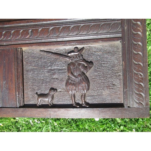 15 - An Antique oak carved panel, with fielded panels  decorated with figure and crest, dated 1633, width... 