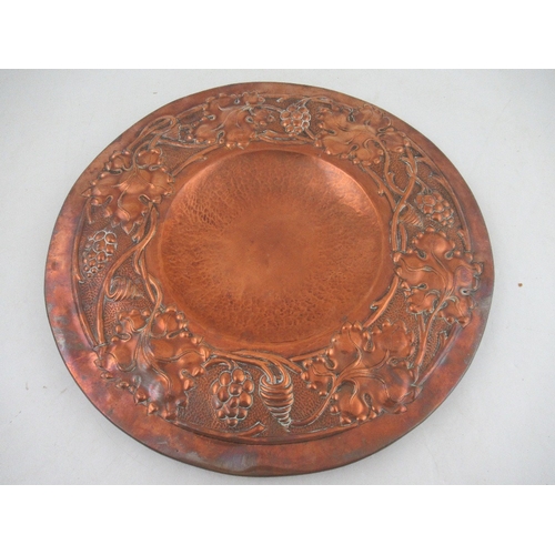 161 - A late 19th century Arts and Crafts  copper alms dish having a concave center surrounded by a border... 