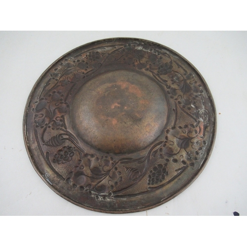 161 - A late 19th century Arts and Crafts  copper alms dish having a concave center surrounded by a border... 