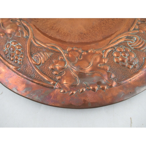 161 - A late 19th century Arts and Crafts  copper alms dish having a concave center surrounded by a border... 