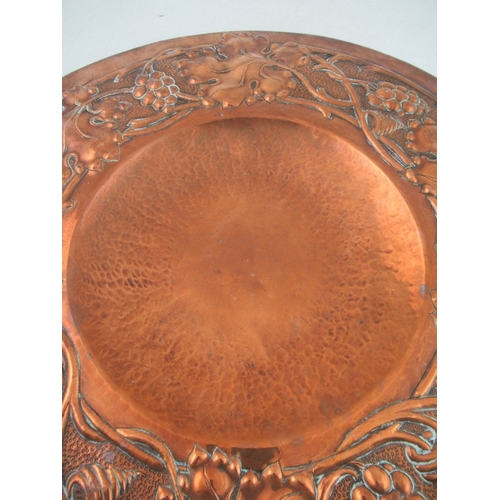 161 - A late 19th century Arts and Crafts  copper alms dish having a concave center surrounded by a border... 