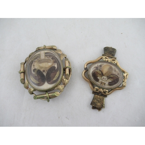 162 - Two 19th century rolled gold memento mori lockets mounted with locks of hair, seed pearls and wire w... 