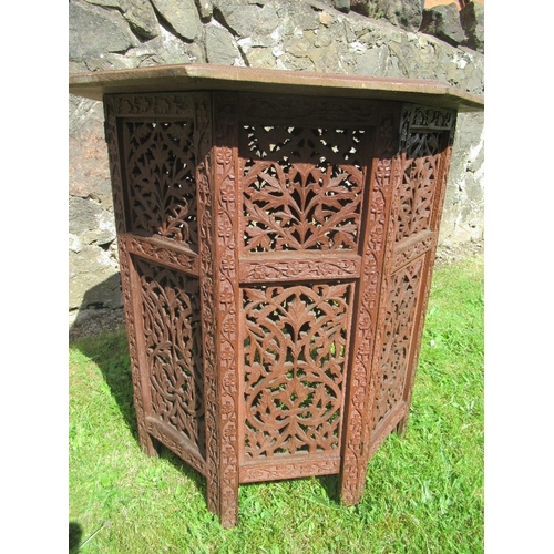 22 - An Eastern design carved  occasional table, with octagonal top, width 24ins, height 25ins