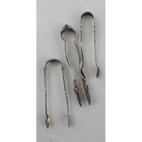 240 - A Scottish silver fiddle pattern sauce ladle, together with three sugar tongs and a butter knife, we... 